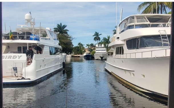 Two large yachts docked conforming to municipal code, creating a navigational bottleneck on the New River